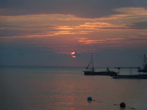 Picture of Jamaican sunset with a boat on the ocean