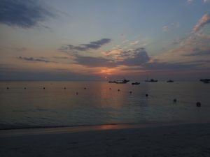 Picture of Jamaican sunset with boats on the ocean in the horizon