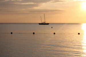 Silhouette of a boat in a Jamaican sunset