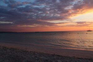 Picture of beautiful Jamaican sunset with boat in background
