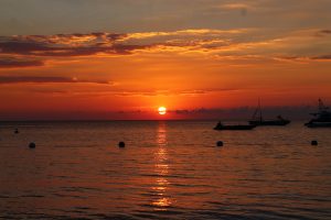 Picture of orange Jamaican sunset with boats