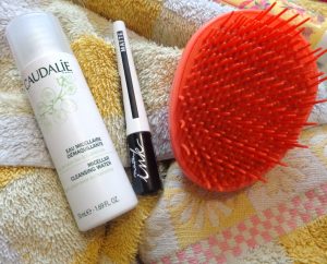 image showing tangle teaser brush, caudalie cleanser and maybelline eyeliner